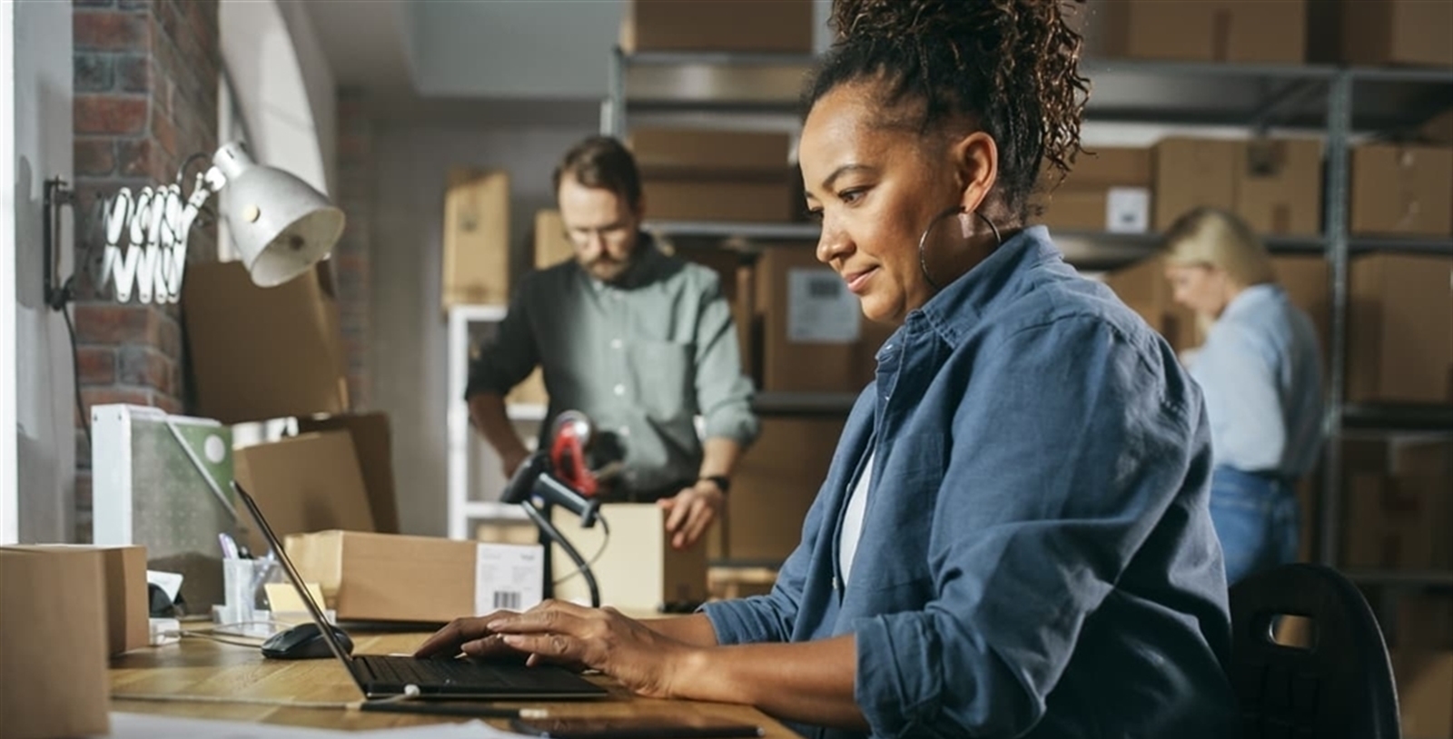 Woman looking at a laptop in a storage room