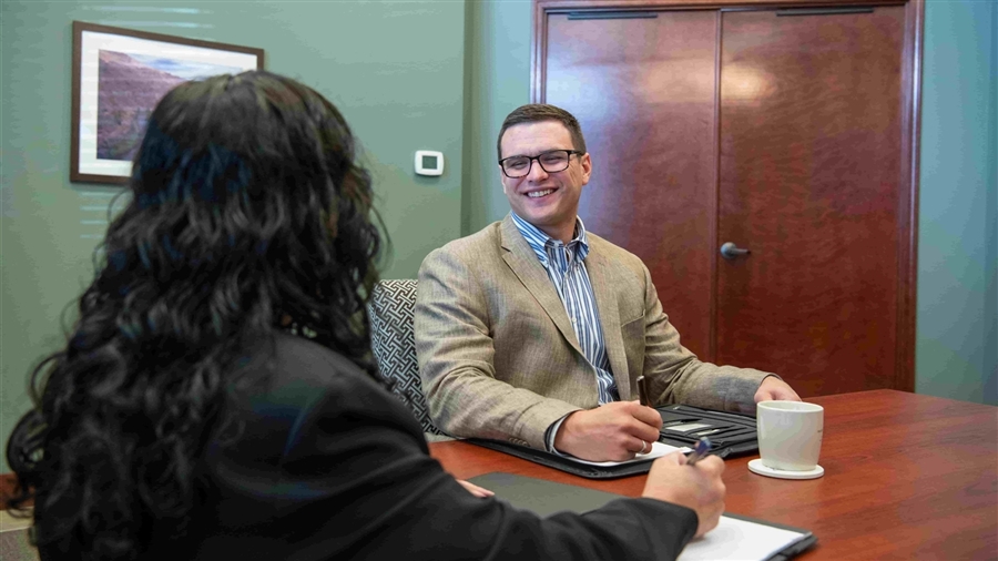 Stuart Gillin, an investment advisor, talking with a client