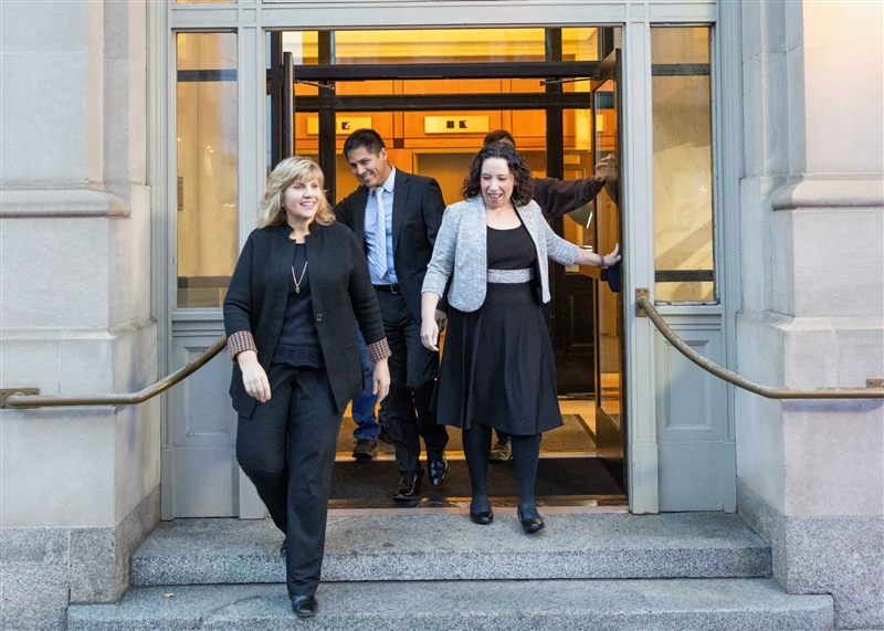 Baker Boyer employees at entrance of bank leaving doors